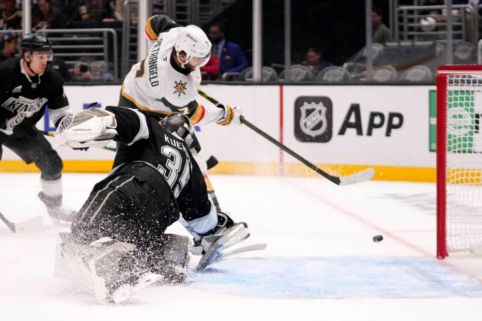 Vegas Golden Knights defenseman Alex Pietrangelo, top, tries to get a shot past Los Angeles Kin ...