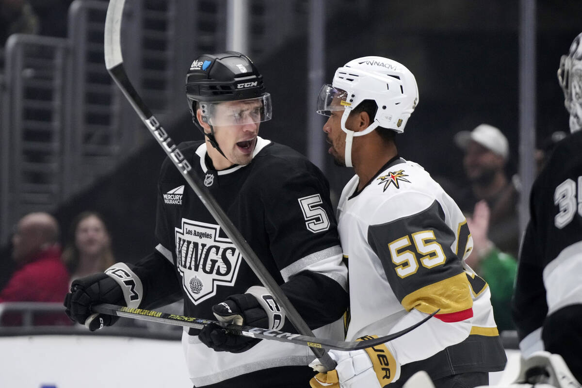 Los Angeles Kings' Andreas Englund, left, and Vegas Golden Knights' Keegan Kolesar jaw at each ...