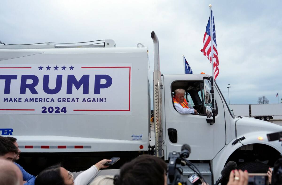 Donald Trump talks to reporters as he sits in a garbage truck Wednesday, Oct. 30, 2024, in Gree ...