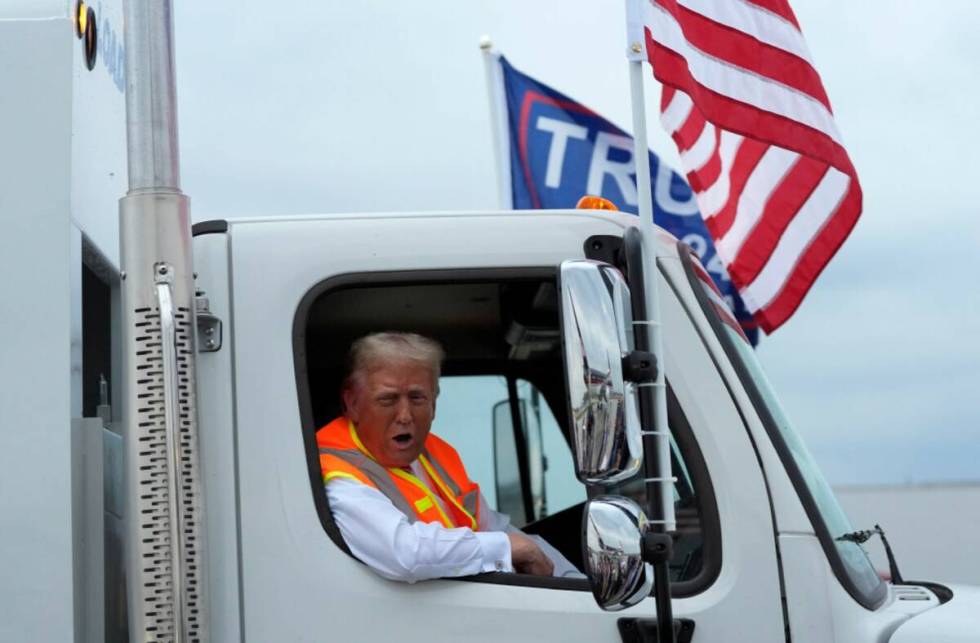 Donald Trump talks to reporters as he sits in a garbage truck Wednesday, Oct. 30, 2024, in Gree ...