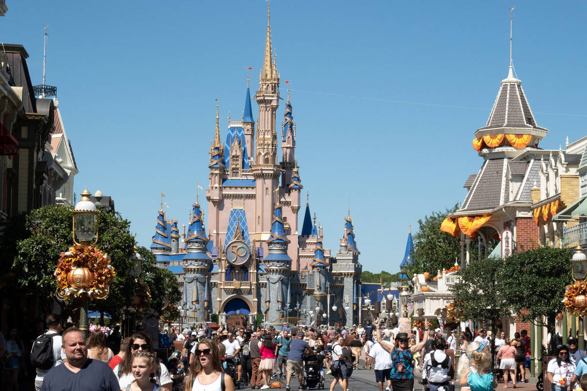 Visitors walk along Main Street at The Magic Kingdom as Walt Disney World reopens following Hur ...