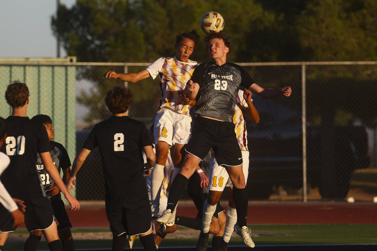 Palo Verde defender Ben Legrand (23) heads the ball against Eldorado defender Daniel Cooke (12) ...