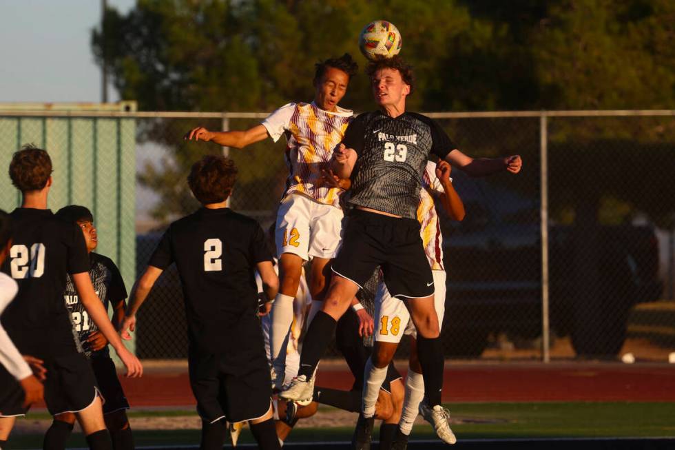 Palo Verde defender Ben Legrand (23) heads the ball against Eldorado defender Daniel Cooke (12) ...