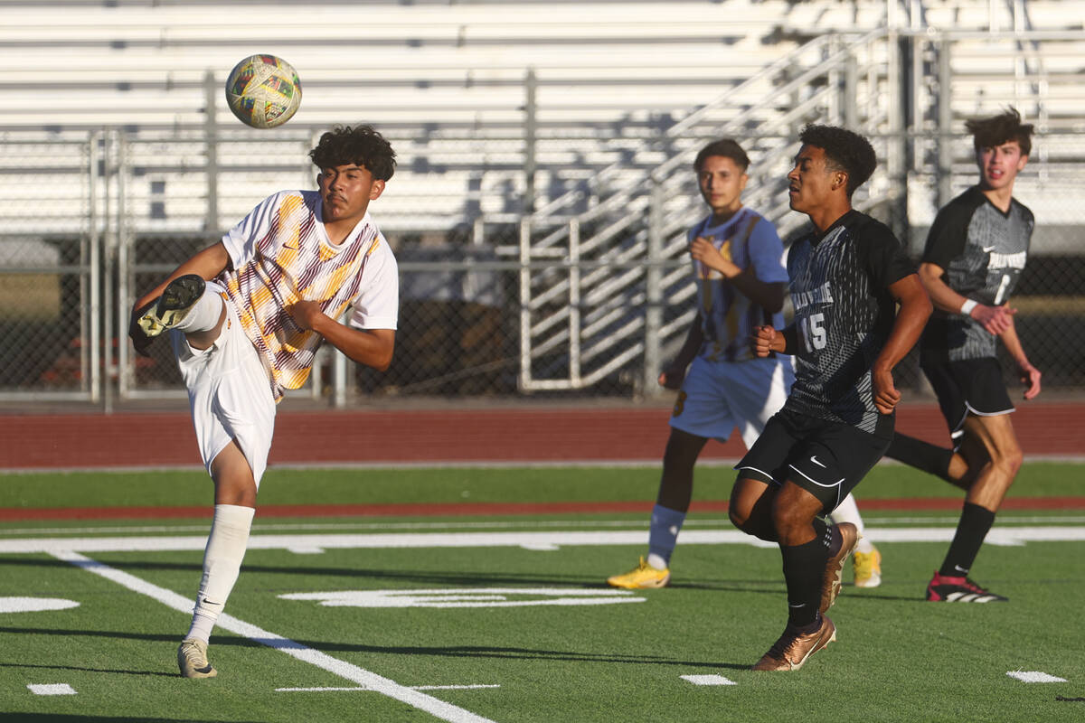 Eldorado’s Angel Lopez (14) kicks the ball as Palo Verde's Trevon Aytch (15) looks on du ...