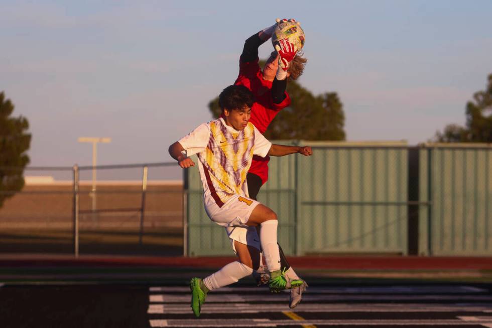 Palo Verde goalkeeper Jake Barrett (0) saves the ball against Eldorado defender Daniel Cooke (1 ...