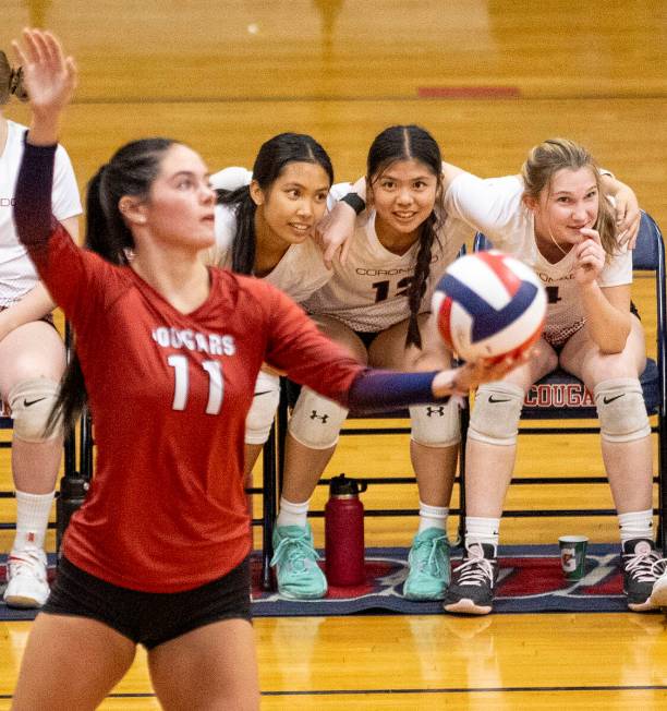 The Coronado bench watches senior Reagan Vint (11) serve the ball during the 5A girls volleybal ...