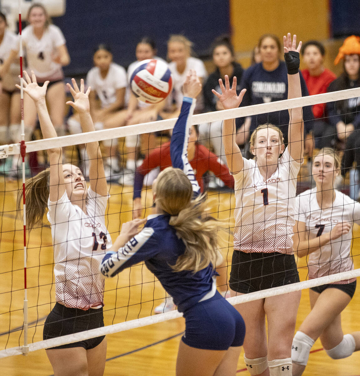 Coronado senior Jeya Dupris (13) and junior Hannah Wayment (1) attempt to block a spike by Cent ...