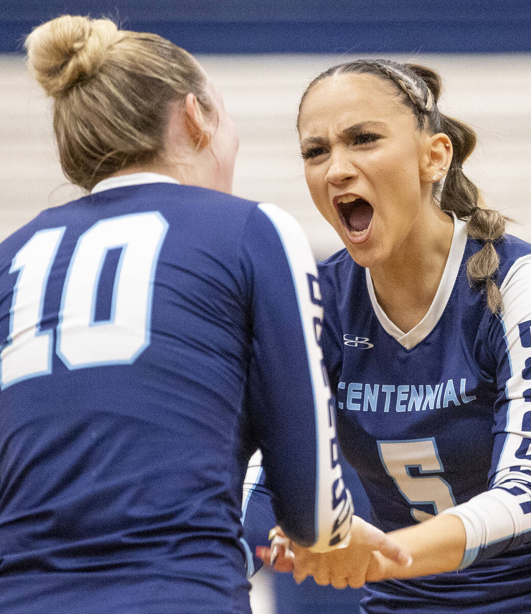 Centennial junior Boggs Caidden (5) celebrates with senior Abby Vlaming (10) during the 5A girl ...