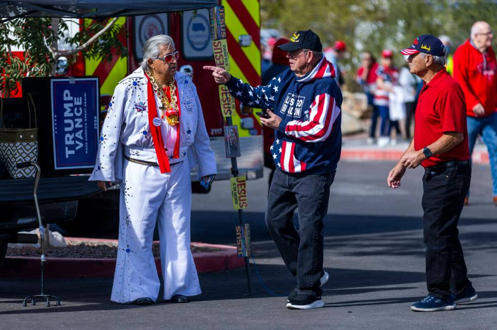 Supporters talk outside in the parking lot before former President Donald Trump arrives for a r ...