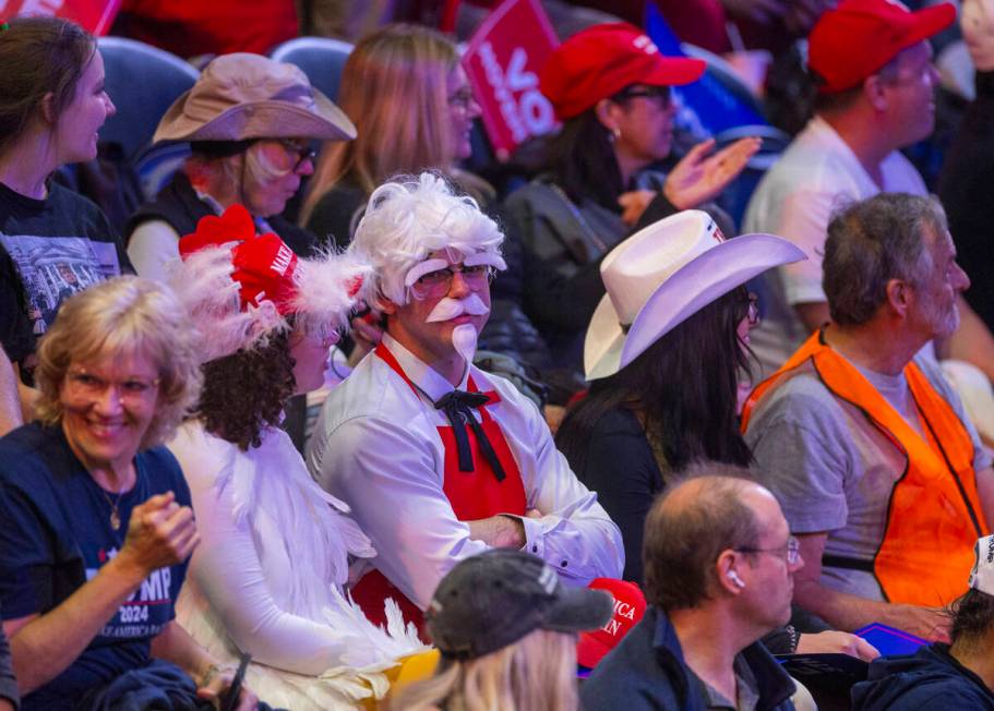 Supporters get ready in their seats before former President Donald Trump arrives during a rally ...