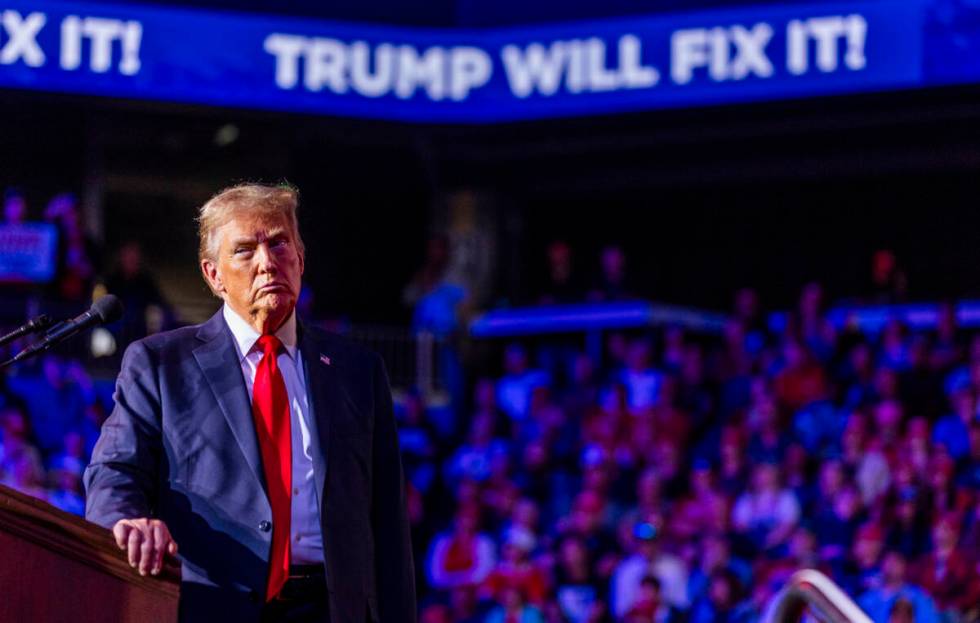 Former President Donald Trump listens to a video presentation as he speaks during a rally at th ...