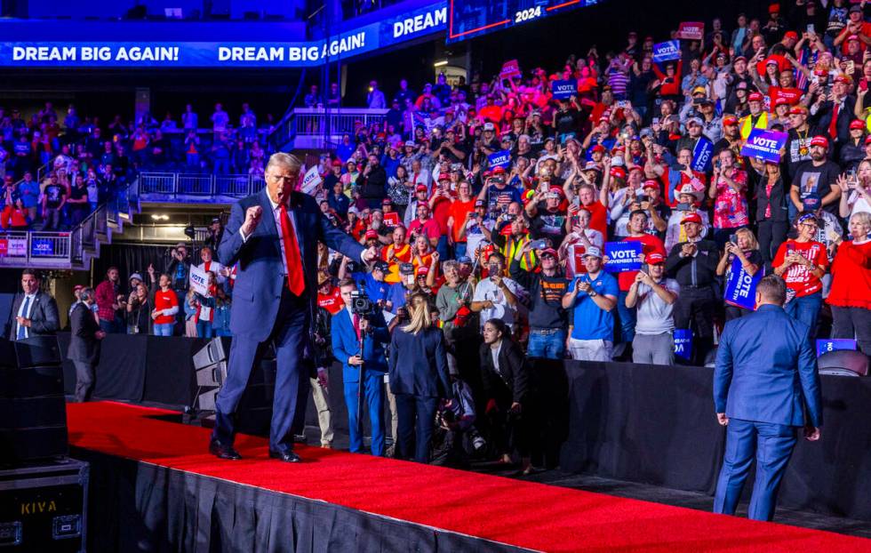 Former President Donald Trump dances with supporters after speaking during a rally at the Lee's ...