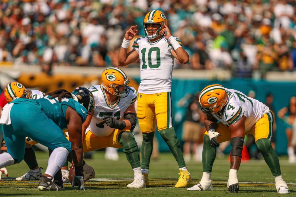 Green Bay Packers quarterback Jordan Love (10) signals during an NFL football game against the ...