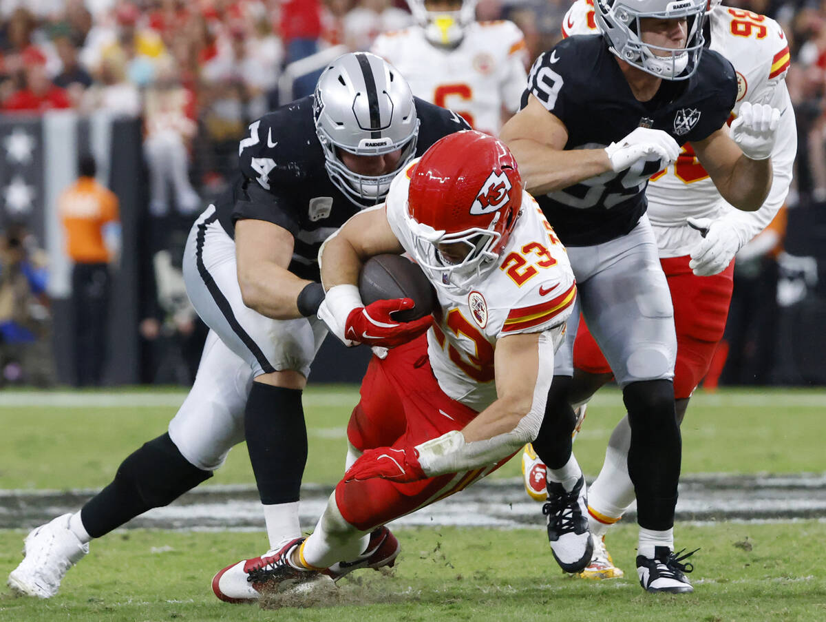 Kansas City Chiefs linebacker Drue Tranquill (23) is taken down by Raiders offensive tackle Kol ...