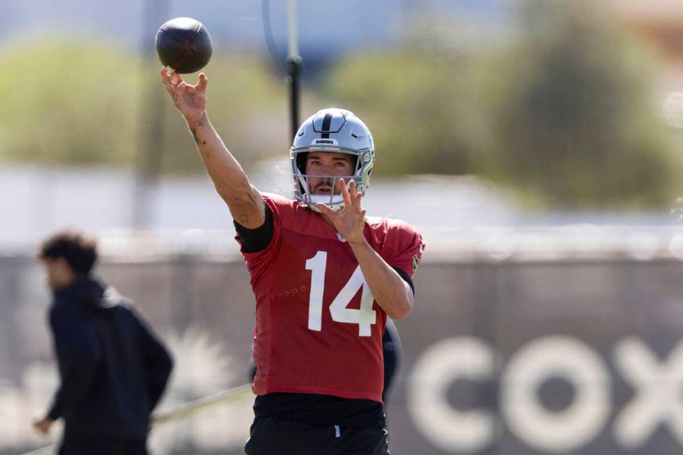 Raiders quarterback Carter Bradley (14) throws the football during team practice at the Intermo ...