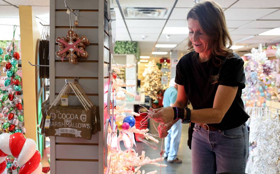 Co-owner Kate Jones powers up a Christmas decoration at Ralph Jones Display at 2576 E. Charlest ...