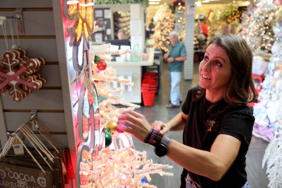 Co-owner Kate Jones powers up a Christmas decoration at Ralph Jones Display at 2576 E. Charlest ...