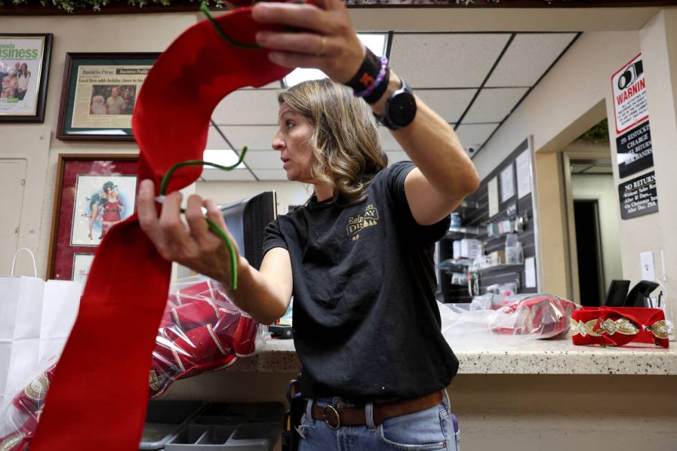 Co-owner Kate Jones shows a Christmas decoration display option for a customer at Ralph Jones D ...