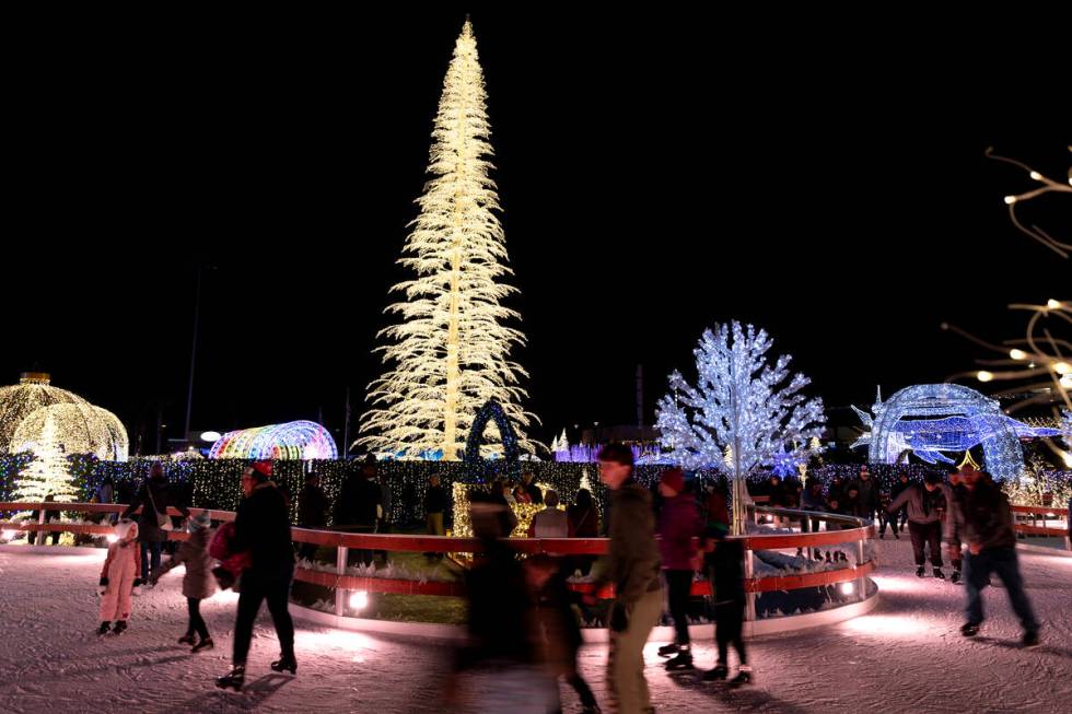 The giant tree is the background for ice skaters during the Enchant light show at the Las Vegas ...