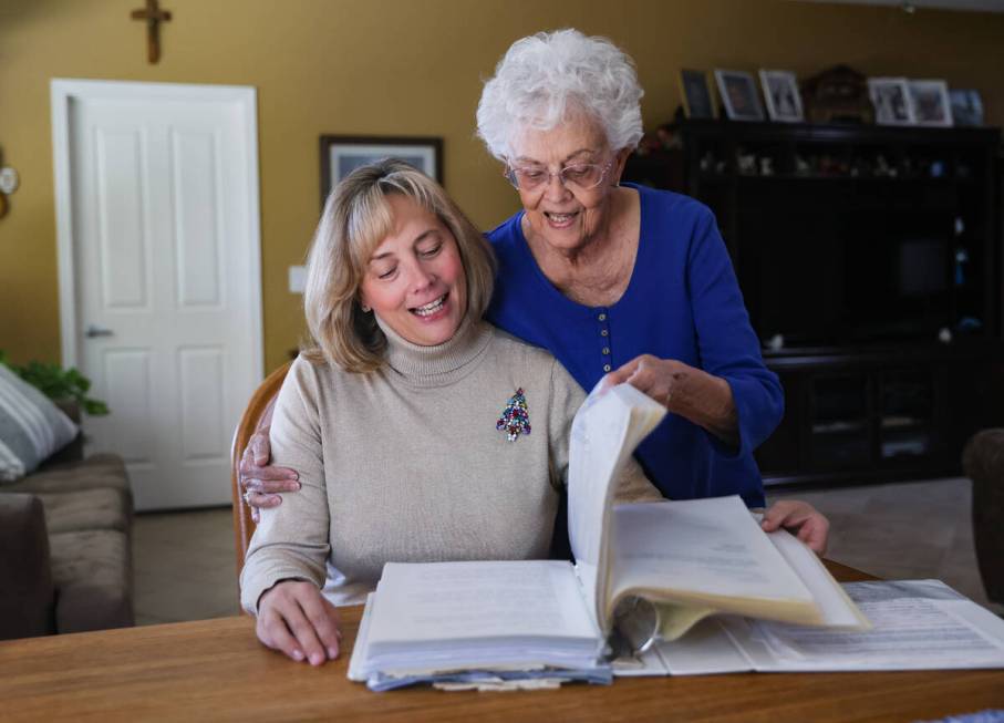 Sharon Willis, left, looks through a cookbook documenting decades of Christmas cookie club reci ...