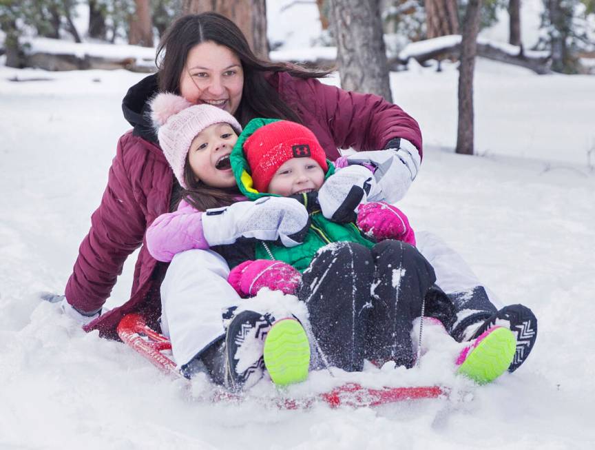 Kristen Richardson, left, rides her sled with daughter Paissyn Richardson, 8, and son Brody Aus ...