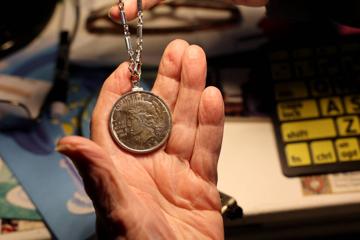 USS Nevada veteran Dick Ramsey, 101, shows a silver dollar given to him from the people of Neva ...