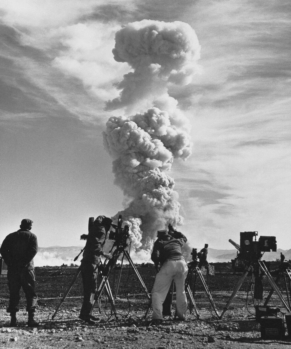 In this June 1953, file photo, film crews photograph an atom cloud forming after an atomic shel ...