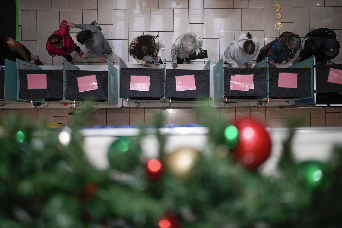 People vote at a shopping mall, Tuesday, Nov. 5, 2024, in Las Vegas. (AP Photo/John Locher)