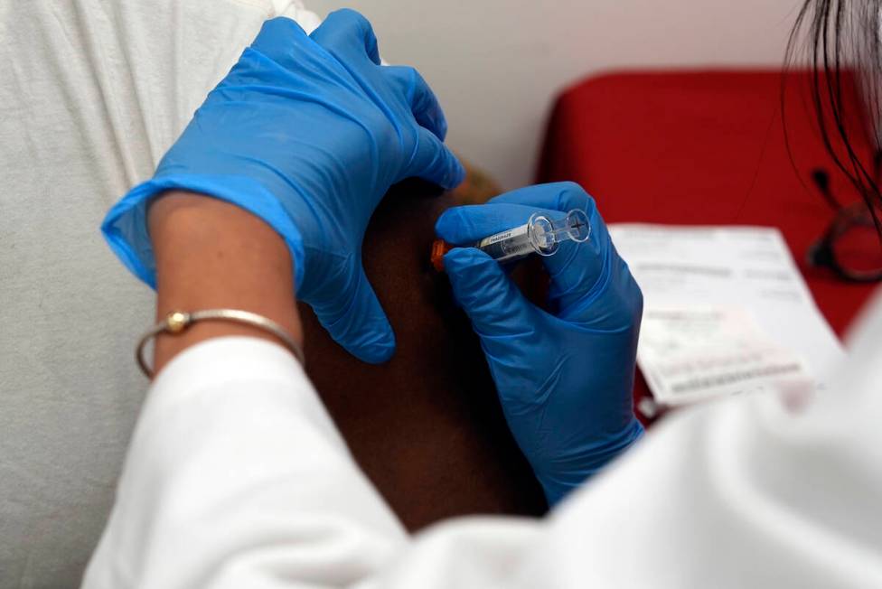 A pharmacist administers a COVID-19 vaccine at a pharmacy in New York, on Tuesday, Sept. 24, 20 ...