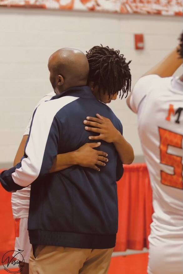 Giali Chapman hugs Abdul Adem, his childhood basketball coach, before a game at Mohave High Sch ...