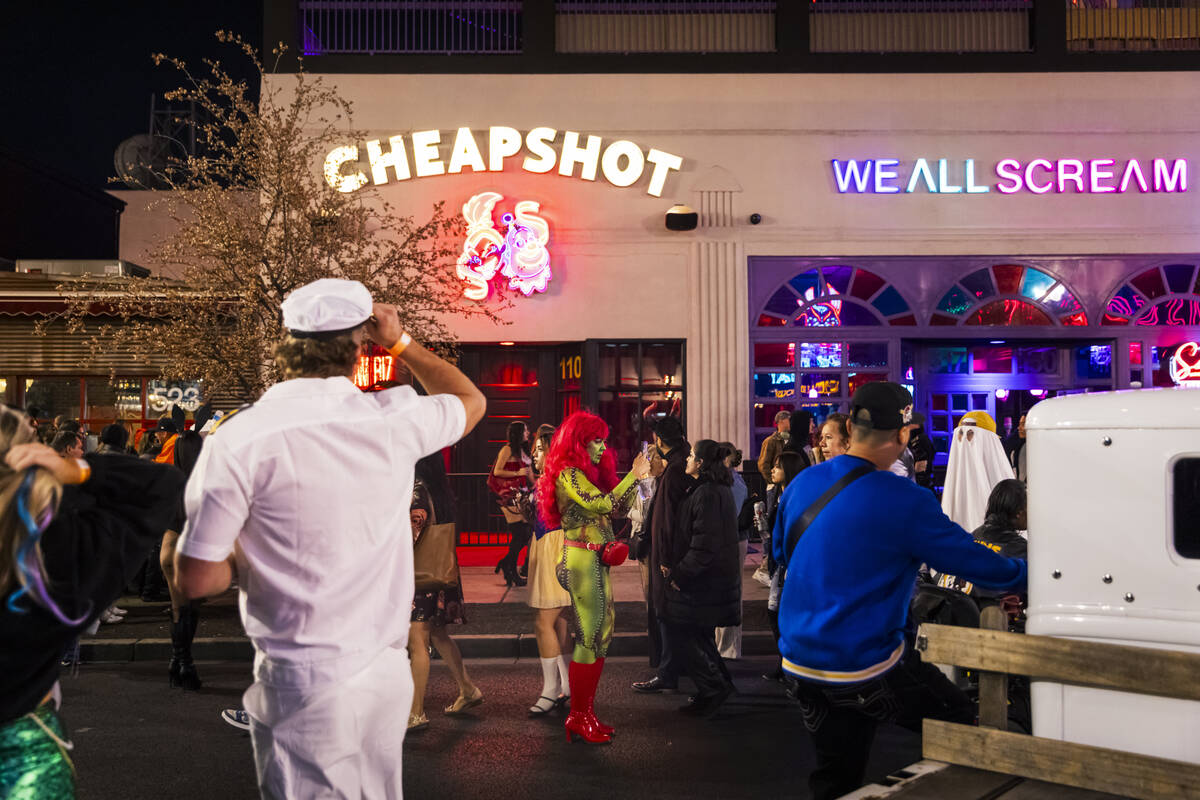 People walk along Fremont Street during Halloween night on Thursday, Oct. 31, 2024, in Las Vega ...