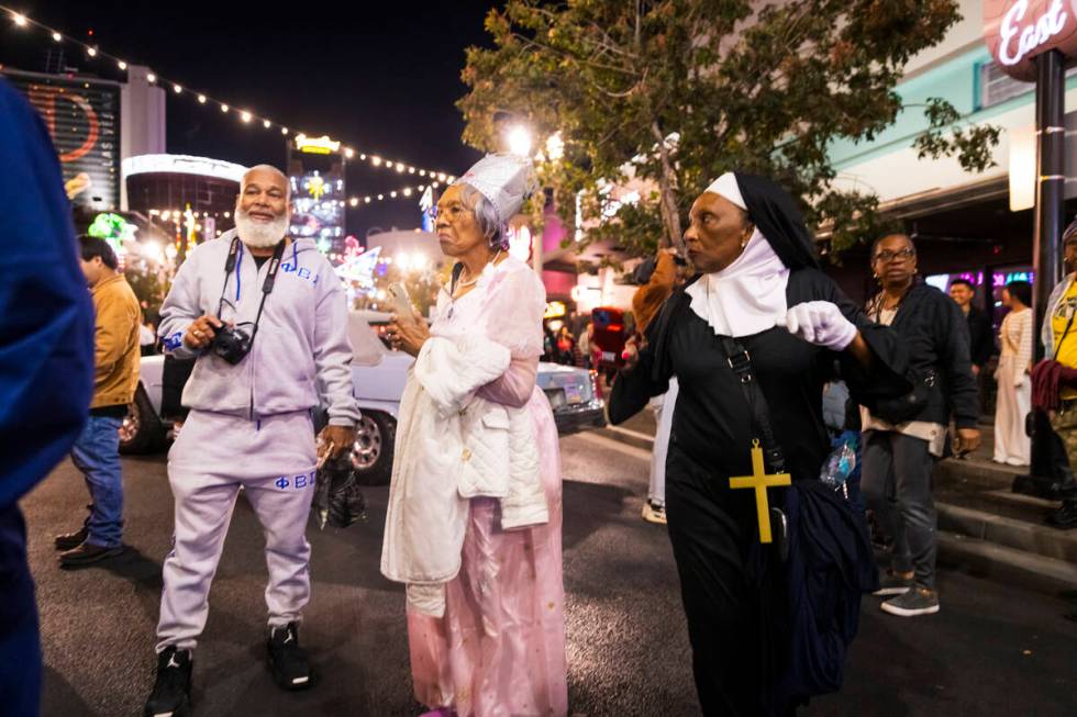 People walk and dance along Fremont Street during Halloween night on Thursday, Oct. 31, 2024, i ...