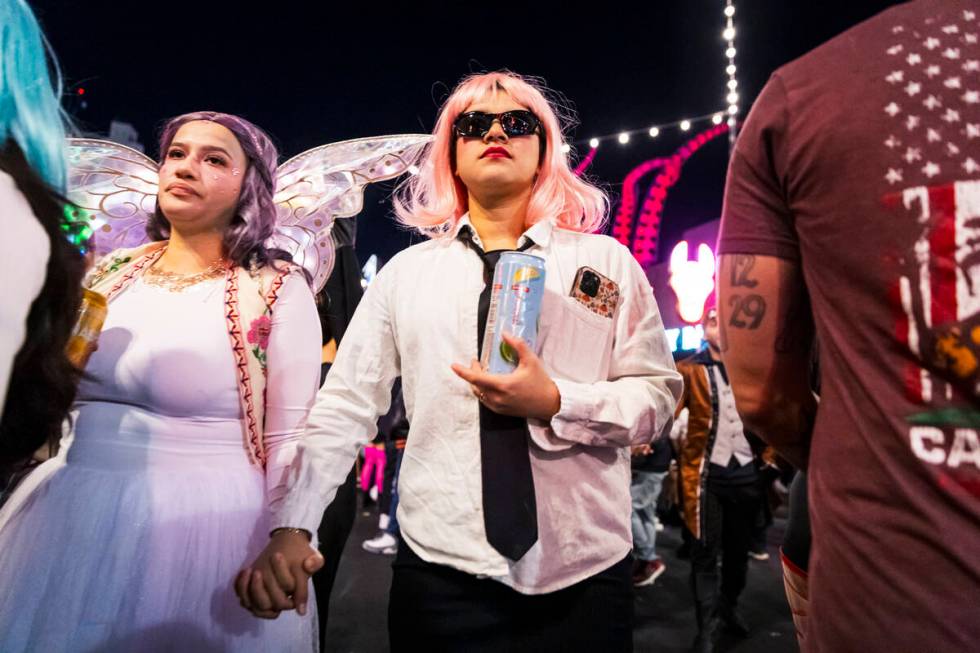 People walk along Fremont Street during Halloween night on Thursday, Oct. 31, 2024, in Las Vega ...