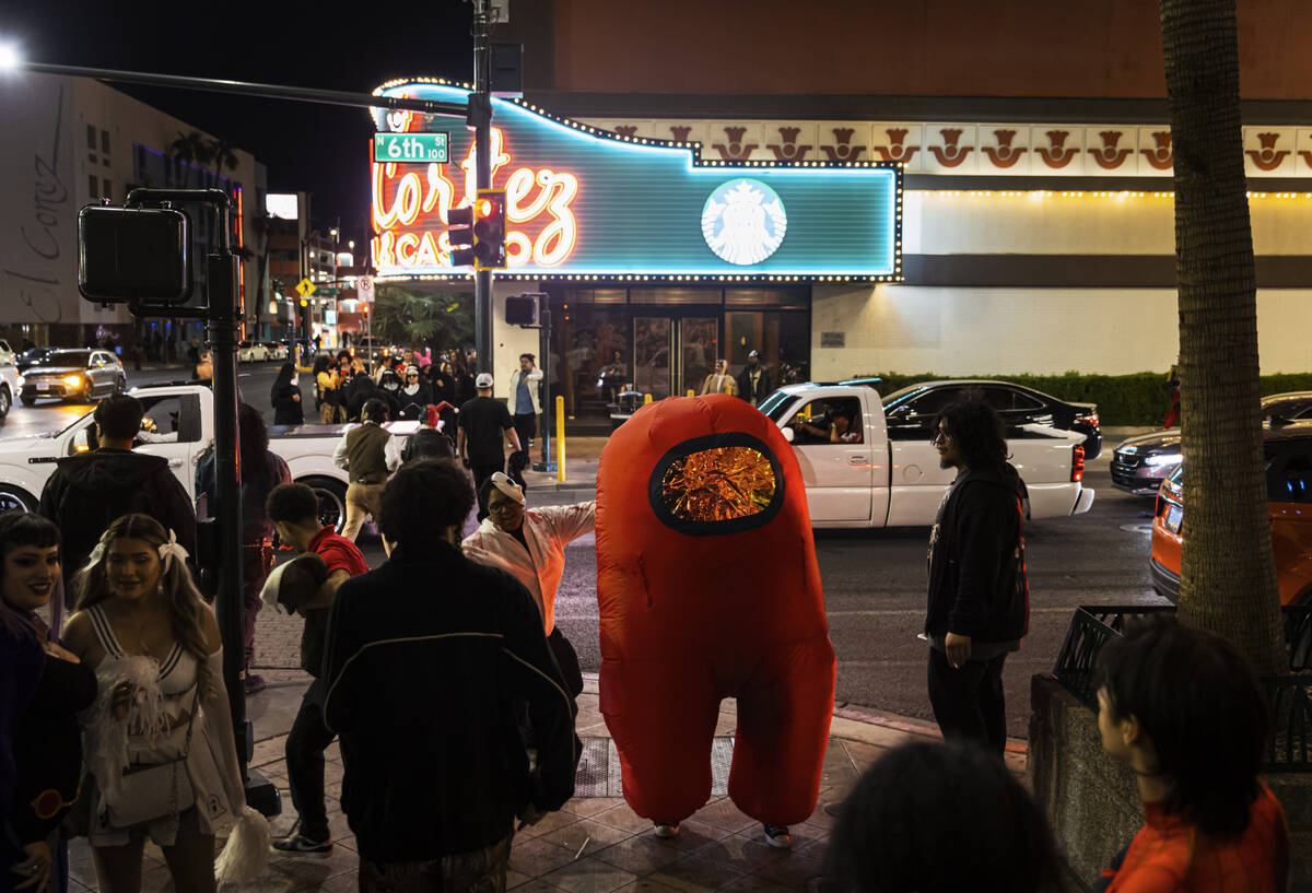 People dance outside of Oddfellows during Halloween night on the early hours of Friday, Nov. 1 ...