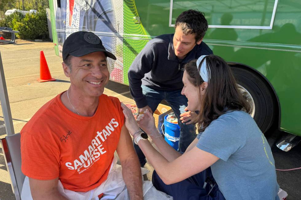 Steven Pieri gets a tetanus shot while he and volunteers with Samaritan’s Purse work on ...