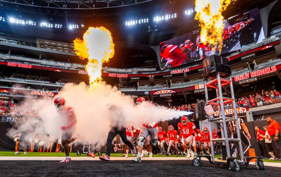 UNLV Head Coach Barry Odom and players take to the field through smoke and fire as the ready to ...