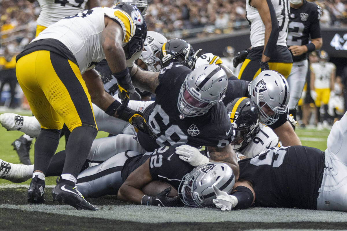 Raiders running back Alexander Mattison (22) pushes into the end zone for a touchdown with Pitt ...