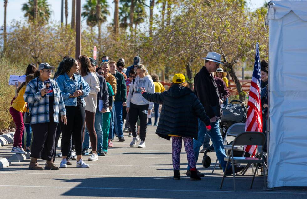 Voters wait in line to cast their ballots on the final day of early voting at the Thunderbird F ...