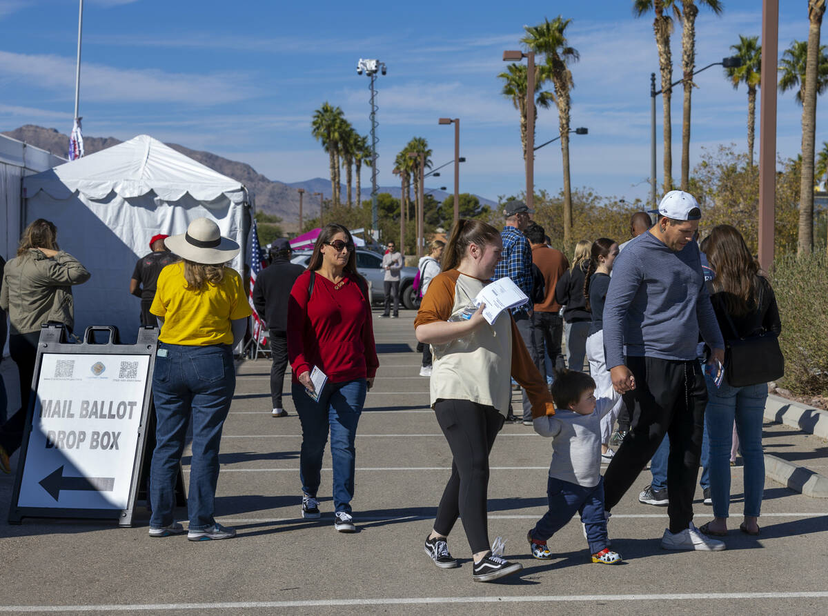 Voters wait in line to cast their ballots on the final day of early voting at the Thunderbird F ...