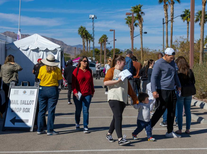 Voters wait in line to cast their ballots on the final day of early voting at the Thunderbird F ...