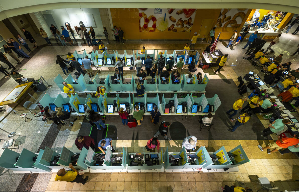 Voters finally get to the front of the line to cast their ballots in a polling spot in the Gall ...