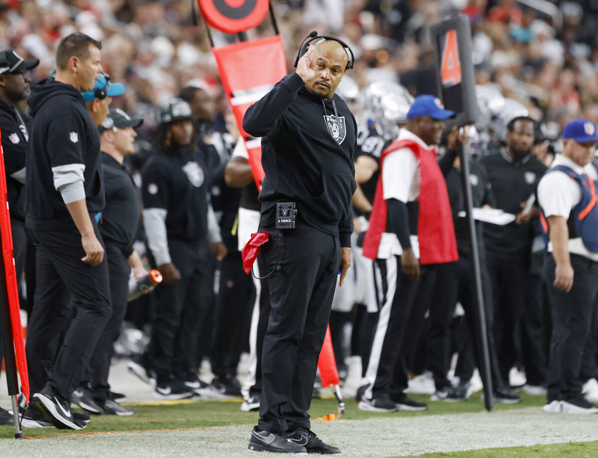 Raiders head coach Antonio Pierce signals as he watches the game from the sidelines during the ...