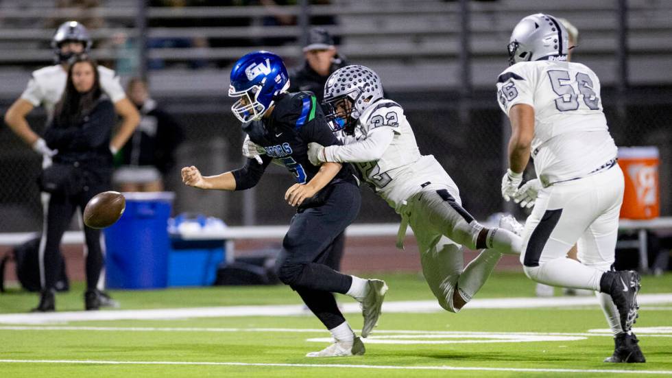 Palo Verde senior Wayne Braxton (32) forces Green Valley quarterback Michael Lewis (15) to fumb ...