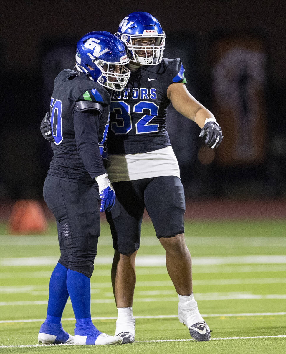 Green Valley senior Shawn Mckeon (50) and senior Richard Aiono (32) celebrate a play during the ...