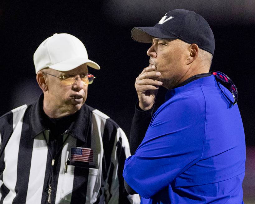 Green Valley Head Coach Bill Powell, right, talks with the referees after a penalty is called o ...