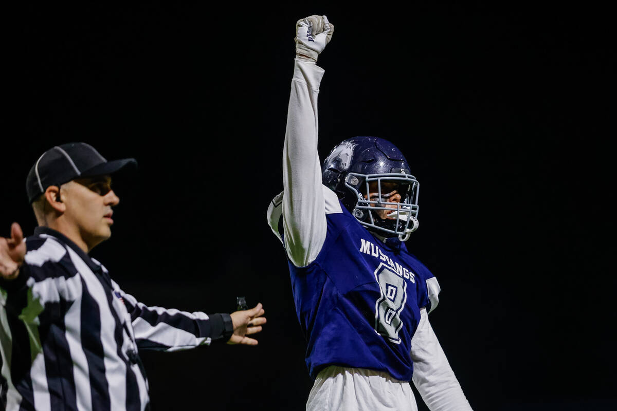 Shadow Ridge Defensive End Colton Ritcher (8) holds up a fourth down signal after preventing a ...