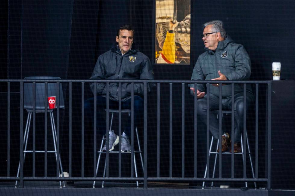 Golden Knights President of Hockey Operations George McPhee listens to general manager Kelly Mc ...