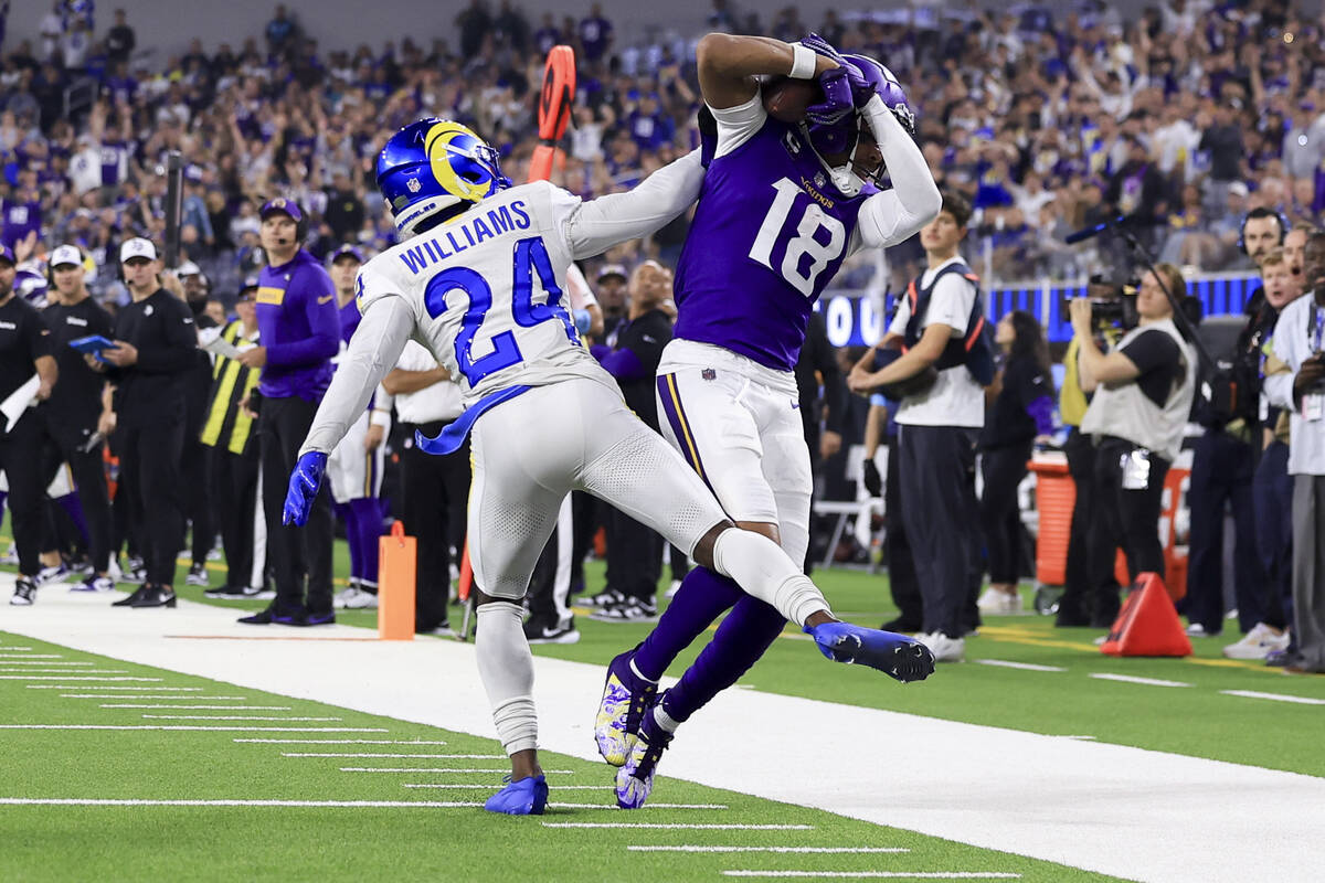 Minnesota Vikings wide receiver Justin Jefferson, right, catches a pass against Los Angeles Ram ...