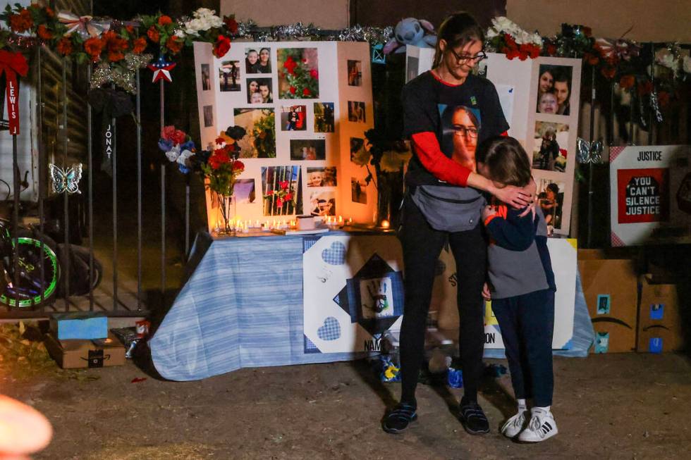 Mellisa Ready, left, hugs her son, who’s name she declined to give, during a vigil for her so ...