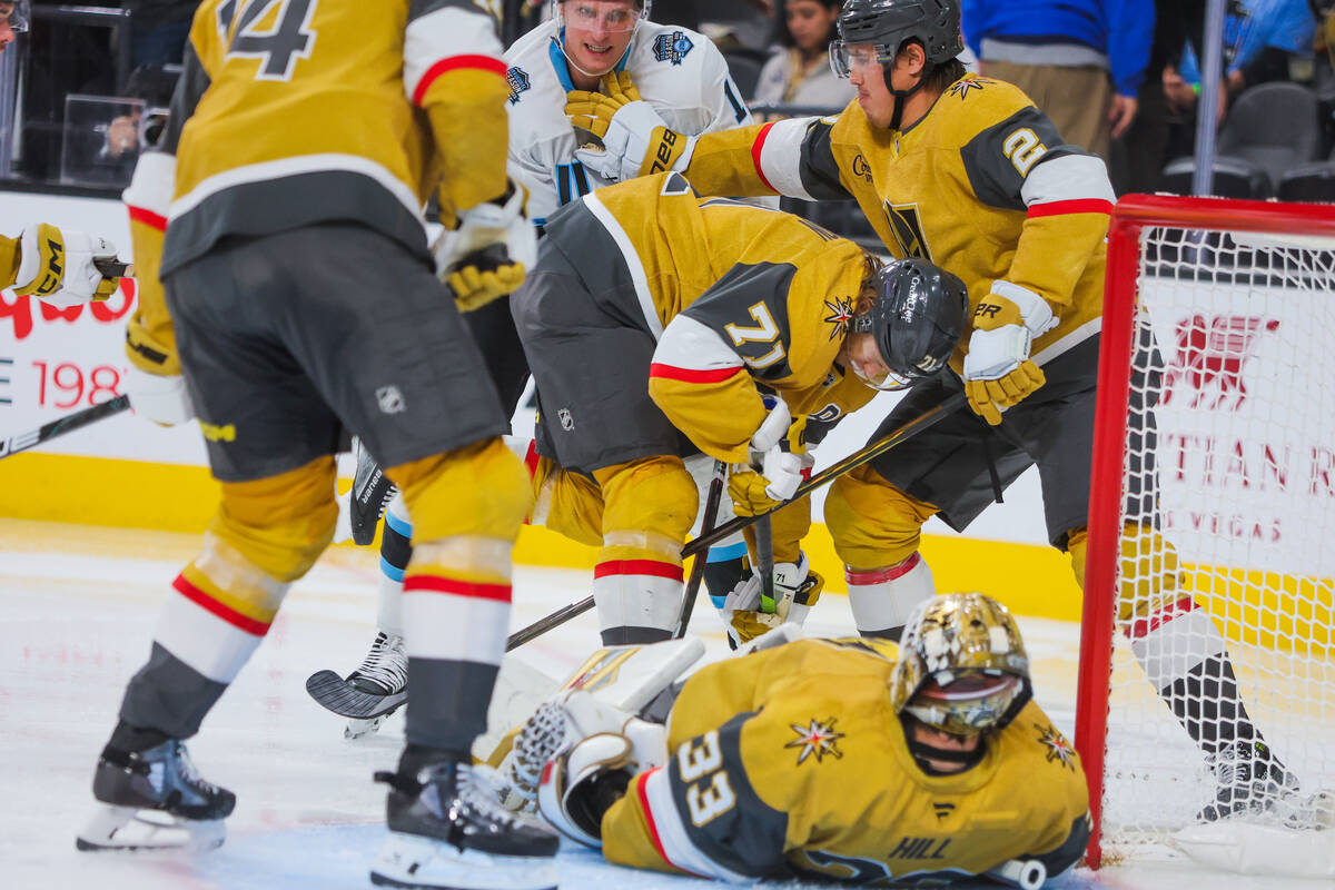 Utah Hockey Club right wing Dylan Guenther (11) tries to make a goal as Golden Knights defensem ...